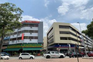 a parking lot with cars parked in front of a building at Puteri Ampang Hotel in Ampang