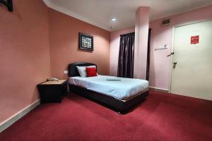 a bedroom with a bed with a red carpet at Puteri Ampang Hotel in Ampang +36 photos