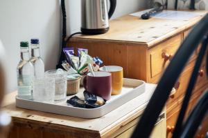 a tray with drinks and other items on a counter at The Tollgate Inn in Bradford on Avon +44 photos