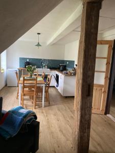 a kitchen and dining room with a table and a kitchen and a table and chairs at Kafírna Ovesné Kladruby in Ovesné Kladruby