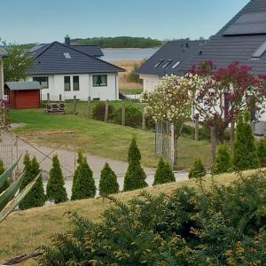 a house with a yard with trees and houses at Dia Mare EG West in Ueckeritz