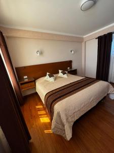 a hotel room with a large bed with two pillows at Asian House in Uyuni