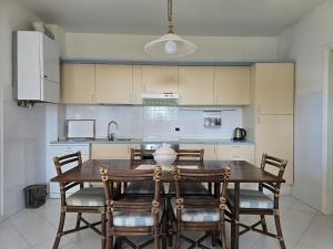 a kitchen with a wooden table and chairs at Casa Limone by Affitti Brevi Liguria in Borgio Verezzi +40 photos