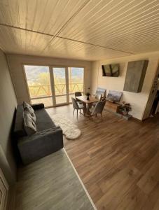a living room with a couch and a table at vaav house in Tyudov
