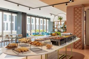 a buffet line with bread and pastries on display at B&B HOTEL Venezia Laguna in Venice