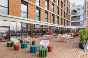 an outdoor patio with tables and chairs in a building at B&B HOTEL Venezia Laguna in Venice +43 photos