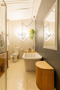 a bathroom with a tub and a toilet and a sink at Lagoon Views in Knysna +27 photos