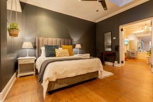 a bedroom with a large bed with yellow pillows at Lagoon Views in Knysna