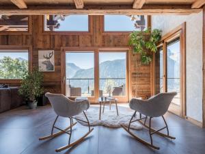 two chairs and a table in a room with windows at Chalet Familial Le Whymper 5 étoiles SPA Sauna Chatel in Châtel