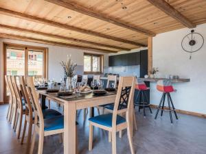 a dining room with a wooden table and chairs at Chalet Familial Le Whymper 5 étoiles SPA Sauna Chatel in Châtel