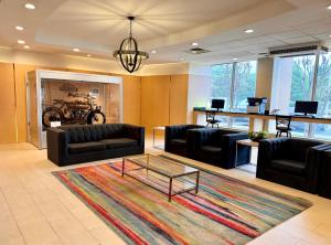 a lobby with couches and a coffee table in a room at Holiday Inn Birmingham-Airport by IHG in Birmingham
