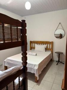 a bedroom with two bunk beds and a table at Casa Zago 2 in Santa Maria Madalena