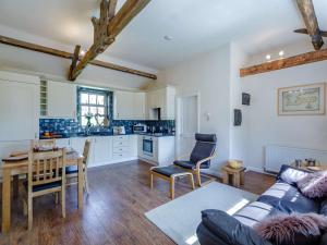 a kitchen and living room with a couch and a table at 1 Bed in Hexham oc-82472 in Hexham