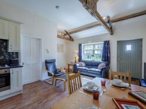 a kitchen and living room with a table and a couch at 1 Bed in Hexham oc-82472 in Hexham +9 photos