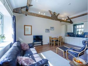 a living room with a leather couch and a table at 1 Bed in Hexham oc-82472 in Hexham