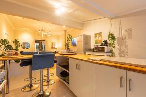 a kitchen with white cabinets and a counter top at Lagoon Views in Knysna