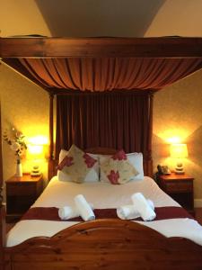 a bedroom with a bed with two towels on it at Healey House Hotel in Batley +67 photos