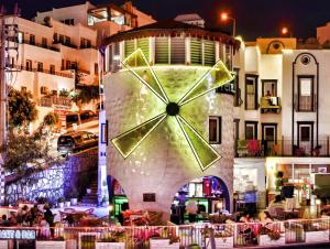 a large clock on the side of a building at Quatro Life Hotel in Bodrum City