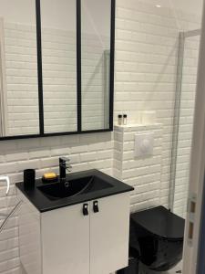 a white bathroom with a sink and a shower at Villa Toscane in Meyreuil