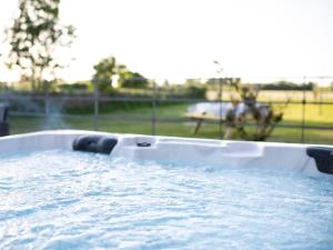 a hot tub filled with water in a field at 1 Bed in Richmond oc-88588 in Easby