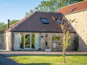 a brick house with a window and a tree at 1 Bed in Richmond oc-88588 in Easby
