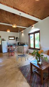 a living room with a swing hanging from a ceiling at Casa Pequi in Alexânia