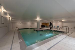 a large swimming pool in a building at Staybridge Suites Denver Downtown by IHG in Denver