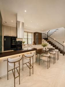 a kitchen with a table and chairs and a staircase at Light House Villa in Da Lat