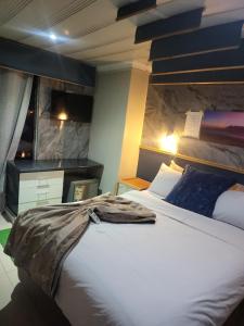 a bedroom with a large white bed in a room at Tshilidzi Guest House in Pretoria +50 photos
