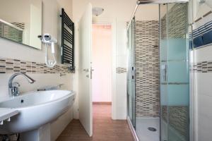 a bathroom with a sink and a shower at PinetoAlba Country House in Scerne +45 photos