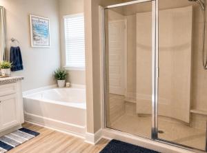 a bathroom with a tub and a shower stall at Windmark-Beach Therapy in Port Saint Joe
