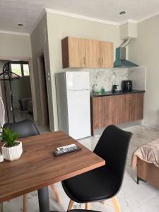 a kitchen with a table and chairs and a refrigerator at Villa Athina C in Serres +26 photos