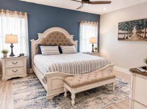 a bedroom with a large bed with a white bedspread at Windmark-Beach Therapy in Port Saint Joe