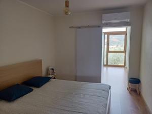 a bedroom with a large bed and a window at Casa da Fraga in Alfândega da Fé