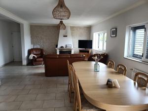 a living room with a table and a couch at Casa da Fraga in Alfândega da Fé