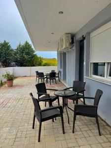 a group of chairs and tables on a patio at Villa Athina C in Serres