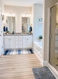 a bathroom with two sinks and a shower at Windmark-Beach Therapy in Port Saint Joe