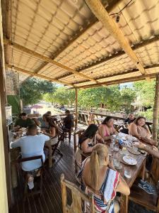a group of people sitting at tables in a restaurant at Pousada Praiana Jericoacora in Jericoacoara