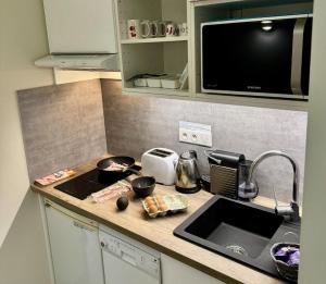 a kitchen counter with a sink and a microwave at Villa Etoile in Cannes