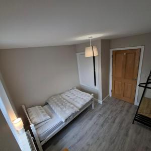 a small bedroom with a bed and a door at Semos in Strabane
