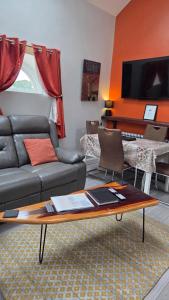 a living room with a couch and a table at Magical 3-Bed Stone Built Cottage - Sleeps 6 in Ballynahinch