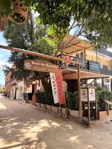 a building with a sign that says ego the outpost at Pousada Praiana Jericoacora in Jericoacoara