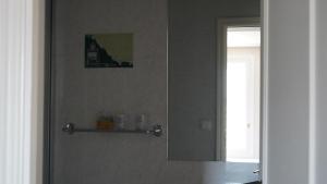 a mirror on the wall of a bathroom at Casa de marinos UribeKosta in Plentzia +16 photos