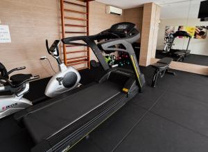a gym with a treadmill and two exercise bikes at Kastel Manibu Recife - Boa Viagem in Recife