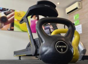 a black object sitting on the floor in front of a gym at Kastel Manibu Recife - Boa Viagem in Recife