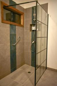 a shower with a glass door in a bathroom at Hotel Patagonia House in Coihaique +84 photos