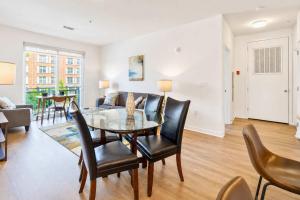a dining room and living room with a table and chairs at Modern Apt Downtown with Pool in Stamford