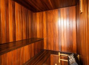 a wood paneled room with a bench in a sauna at Kastel Manibu Recife - Boa Viagem in Recife