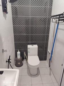 a small bathroom with a toilet and a sink at ZIRA STAY PENARIK - Ziyad Room in Kampong Ru Sepuloh