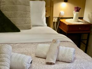 a bedroom with a bed with towels on it at Studio close to Train Station in Larisa